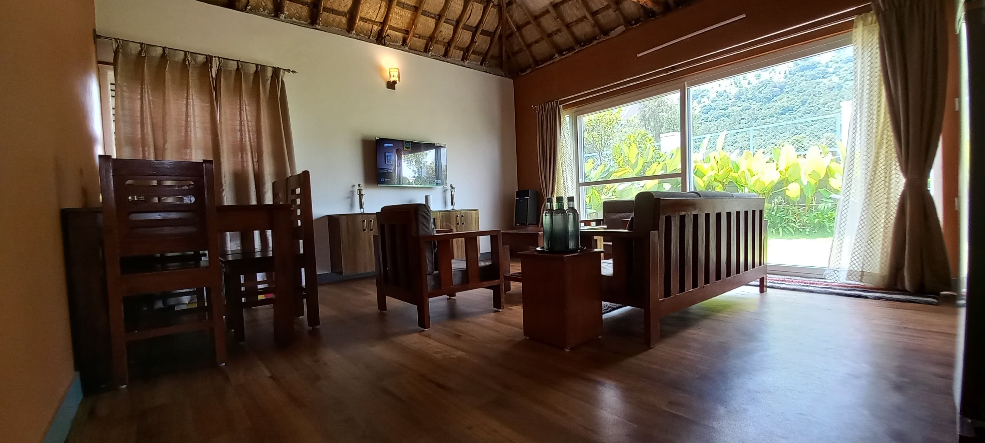 Living room with wooden furniture and garden view